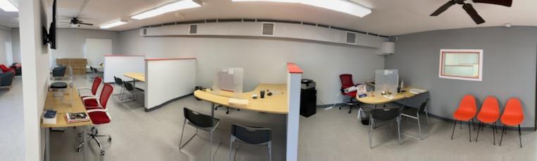 A panoramic view of an office with chairs and tables.